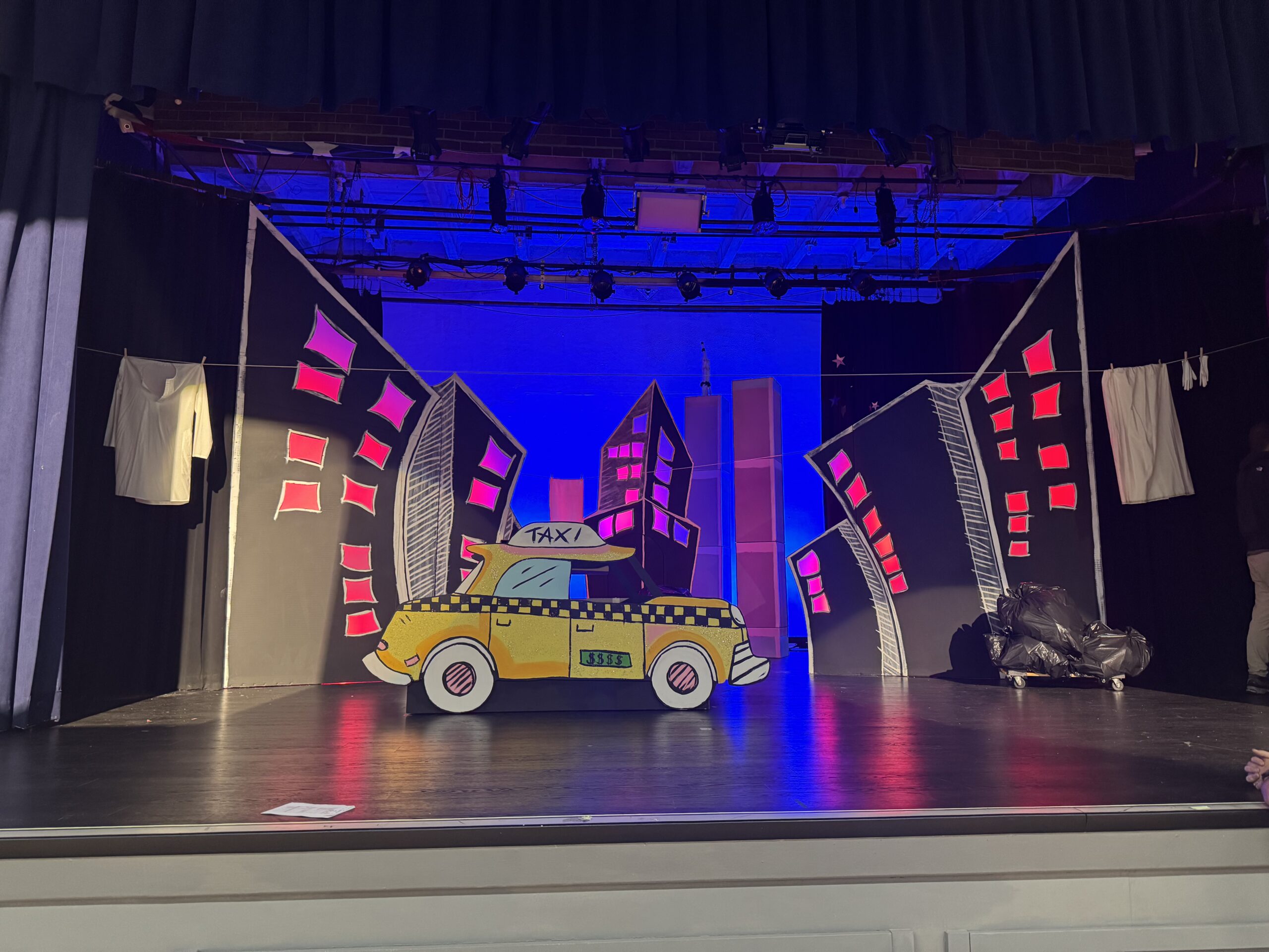 Theater set, school play. Painted cityscape and taxi.